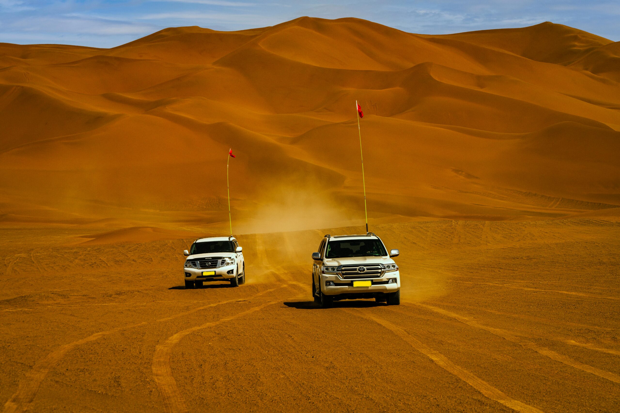 4x4 vehicle performing dune bashing on sad dunes in the Arabian desert. standard desert safari